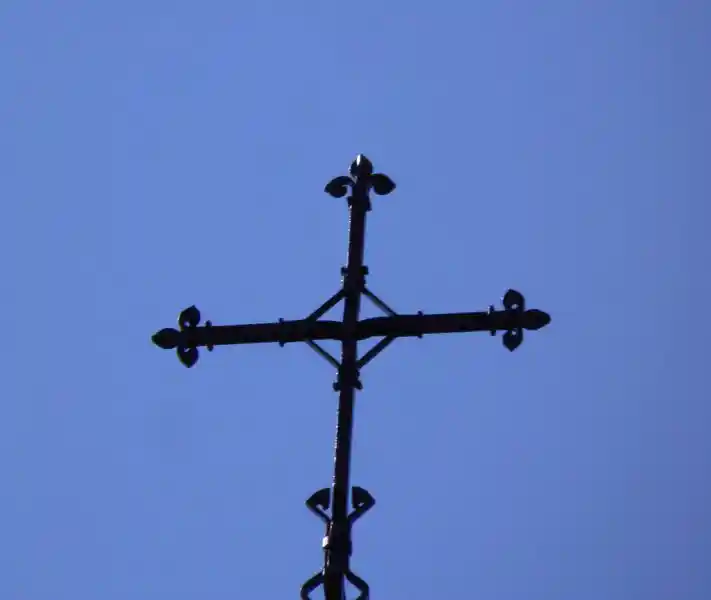 Cross with diamond on the center on top of a steeple